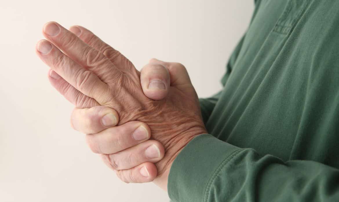 Older man rubbing his hand