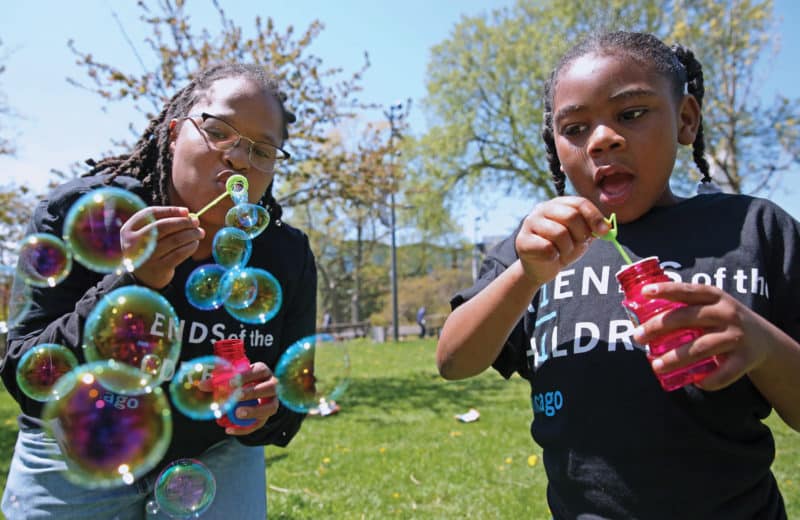 Photo courtesy of friends of the children. mentor and mentee blowing bubbles. mentorship