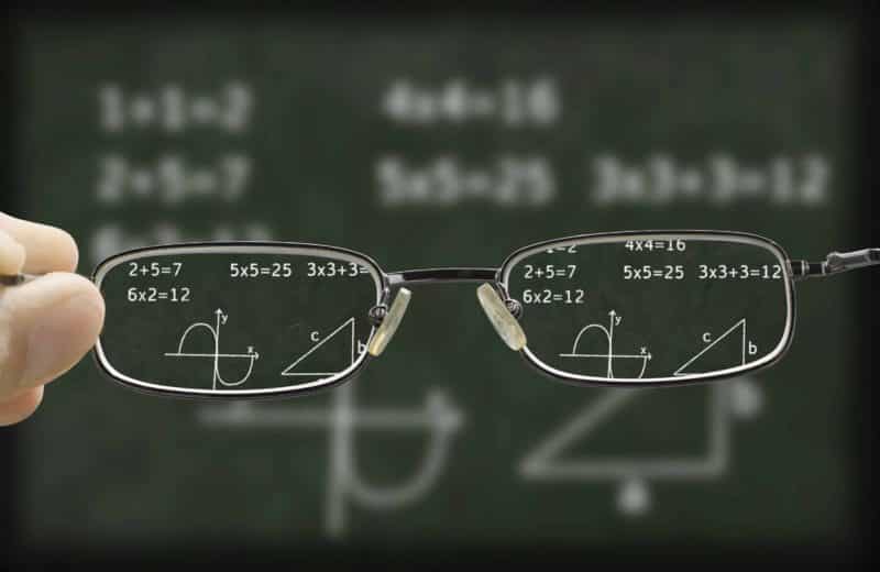 Eyeglasses with blurred chalkboard behind