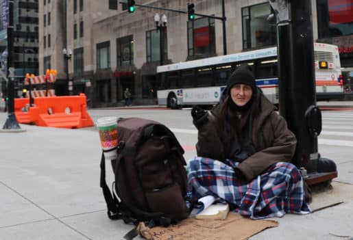 Stacey smokes a cigarette while panhandling near Union Station. Photo by Caroline Catherman