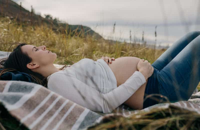 Pregnant woman caressing her tummy sleeping