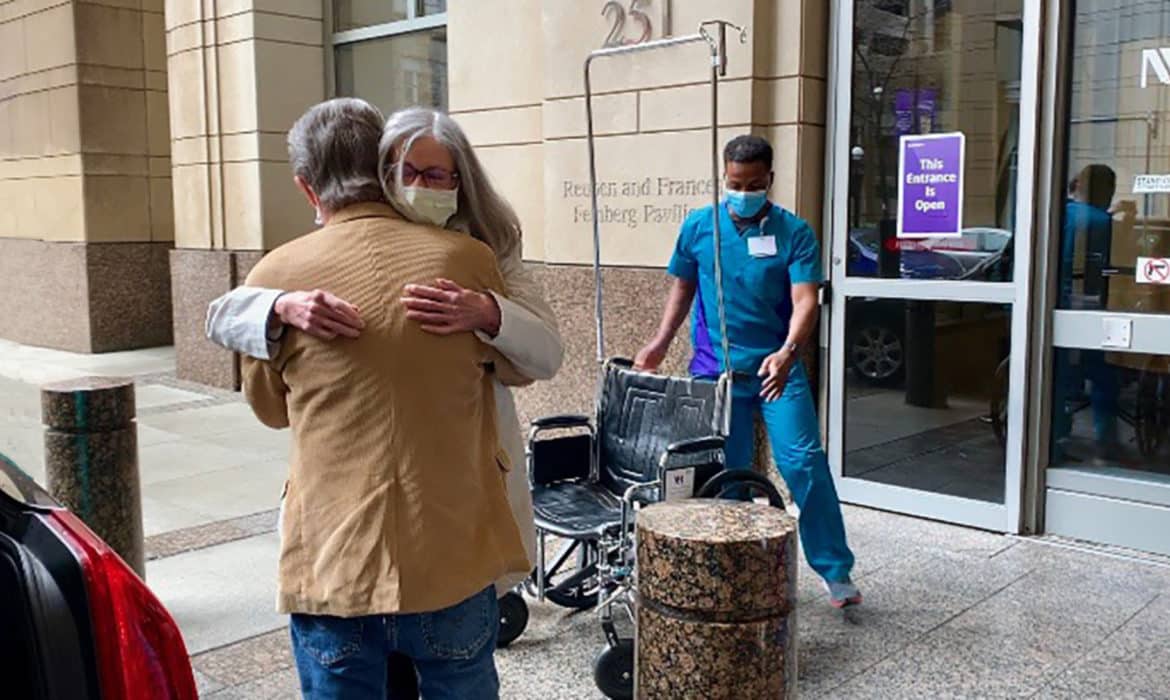 Barbara Creed hugging her husband after being released from the hospital