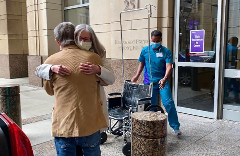 Barbara Creed hugging her husband after being released from the hospital