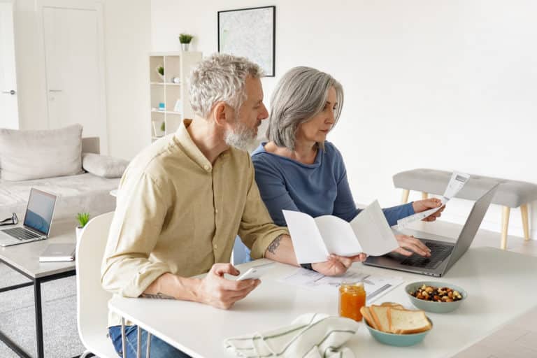 Middle aged couple reviewing medical bills