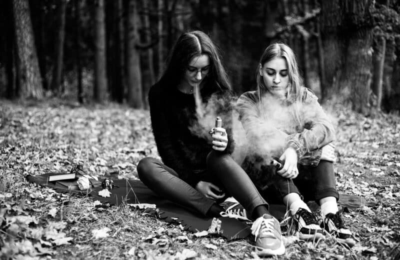 Teenagers vaping in a forest preserve