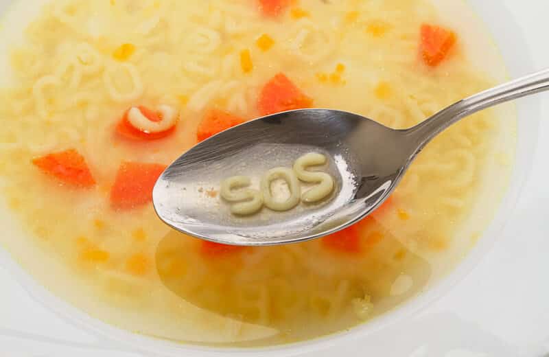Alphabet letters in spoon spell out "Sos". Alphabet Soup Pasta.