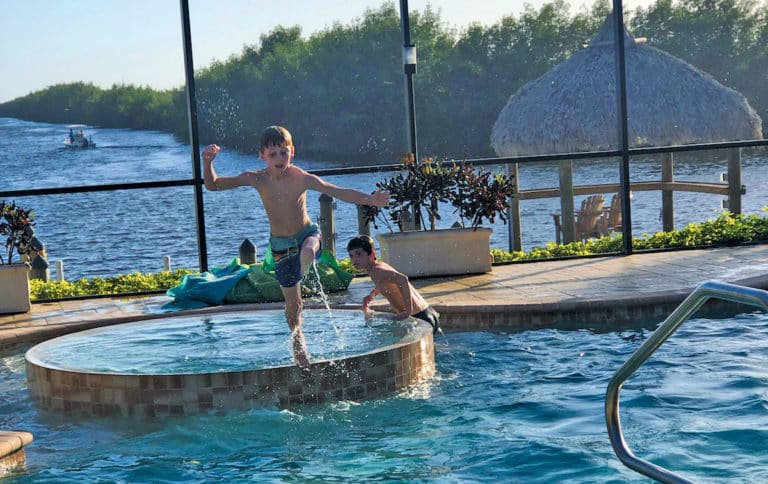 Tommy O’Leary (jumping in) and his brother Seamus swim while visiting their great grandparents during Christmas break