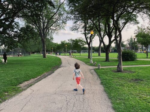 Young child runs down a path in Portage Park, on Chicago's Northwest side.
