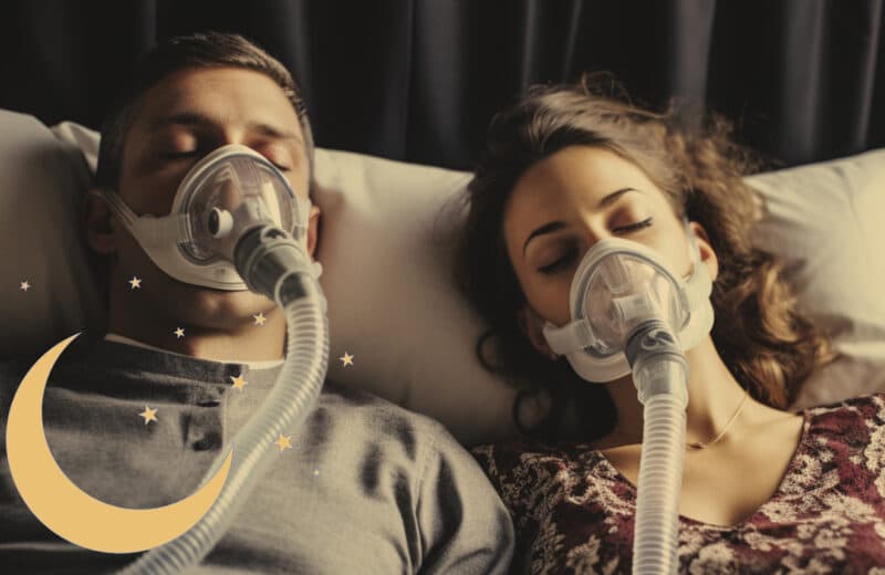 Couple both wearing a CPAP machine in bed. Sleep disorder concept.