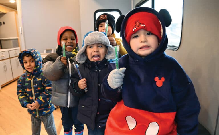 Mobile Care Chicago dental van. Children hold their new toothbrushes inside the Mobile Care Chicago’s Dental Van. The van visited Pathways To Learning Child Care Center (6535 S. Kedzie Ave.) in Chicago on Jan. 11, 2024.