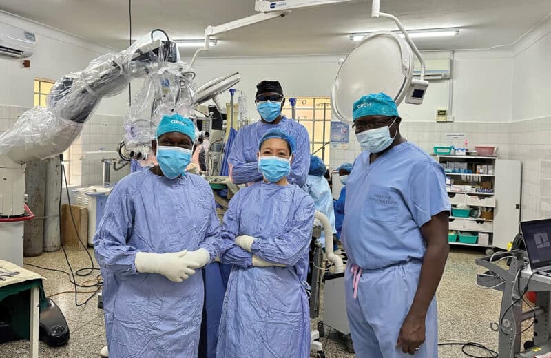 Sandi Lam, MD (center) along with physicians on the CURE Uganda team in the operating room.