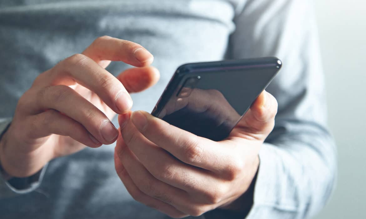 Closeup of hand with smartphone, long covid apps