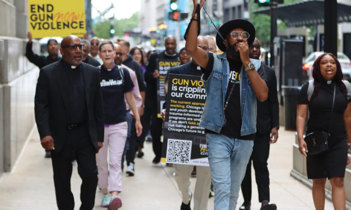 Rev. Ciera Bates-Chamberlain (pictured far right), and Live Free Illinois at a protest against gun violence. LiveFree Illinois is a faith based organization