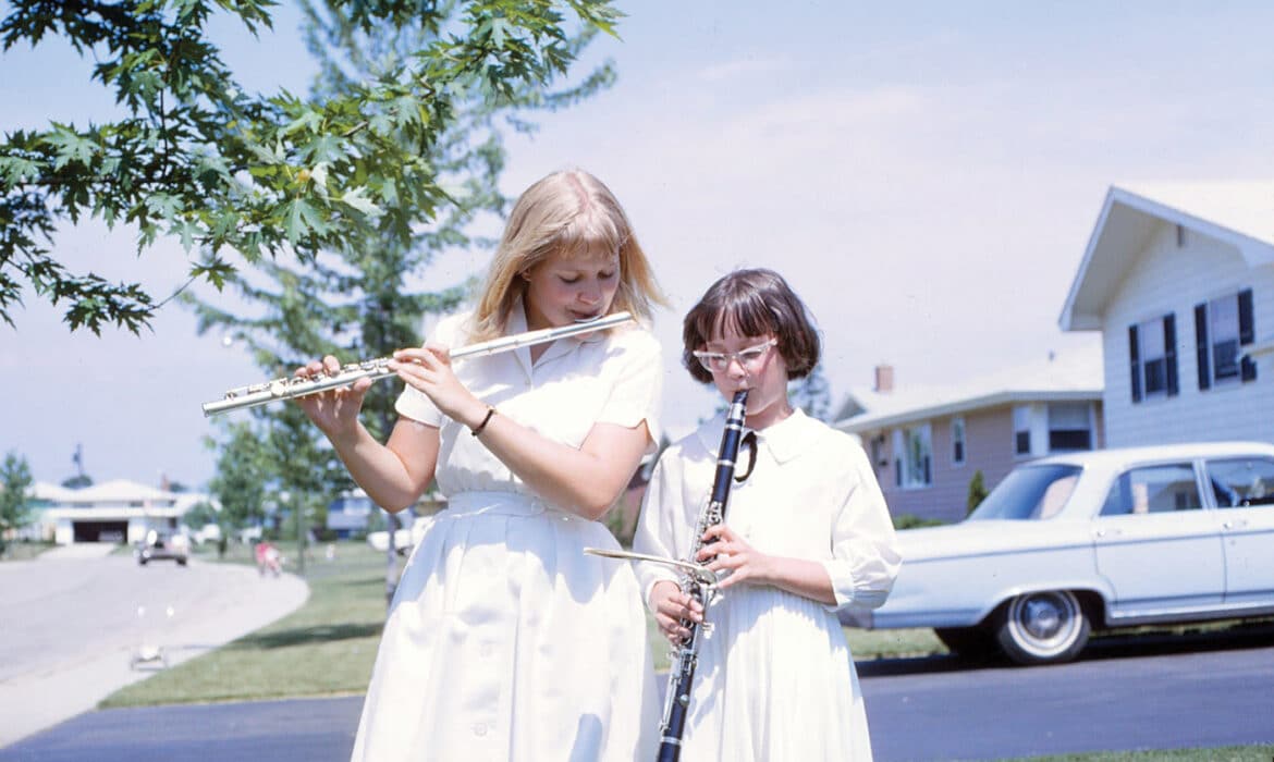 Janice Frank pictured on left plays the flute alongside her sister, Joyce. Frank was later diagnosed with Bow hunters syndrome,