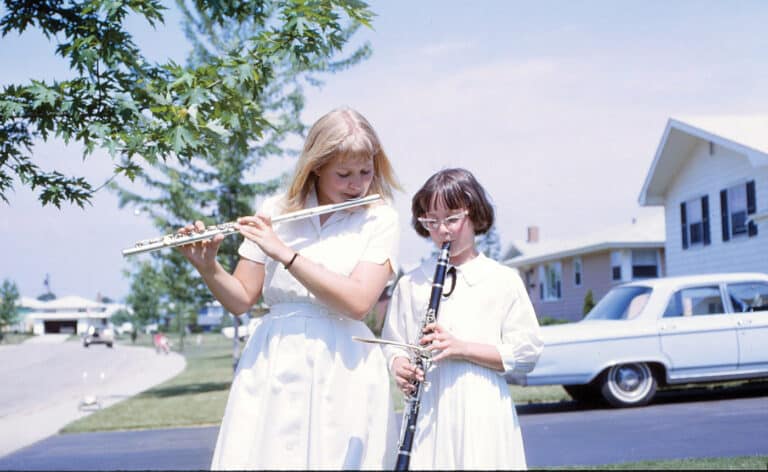 Janice Frank pictured on left plays the flute alongside her sister, Joyce. Frank was later diagnosed with Bow hunters syndrome,