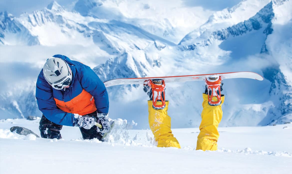 Fallen snowboarder on back with legs up in the air. Humorous photo representing the dangers of snow sports