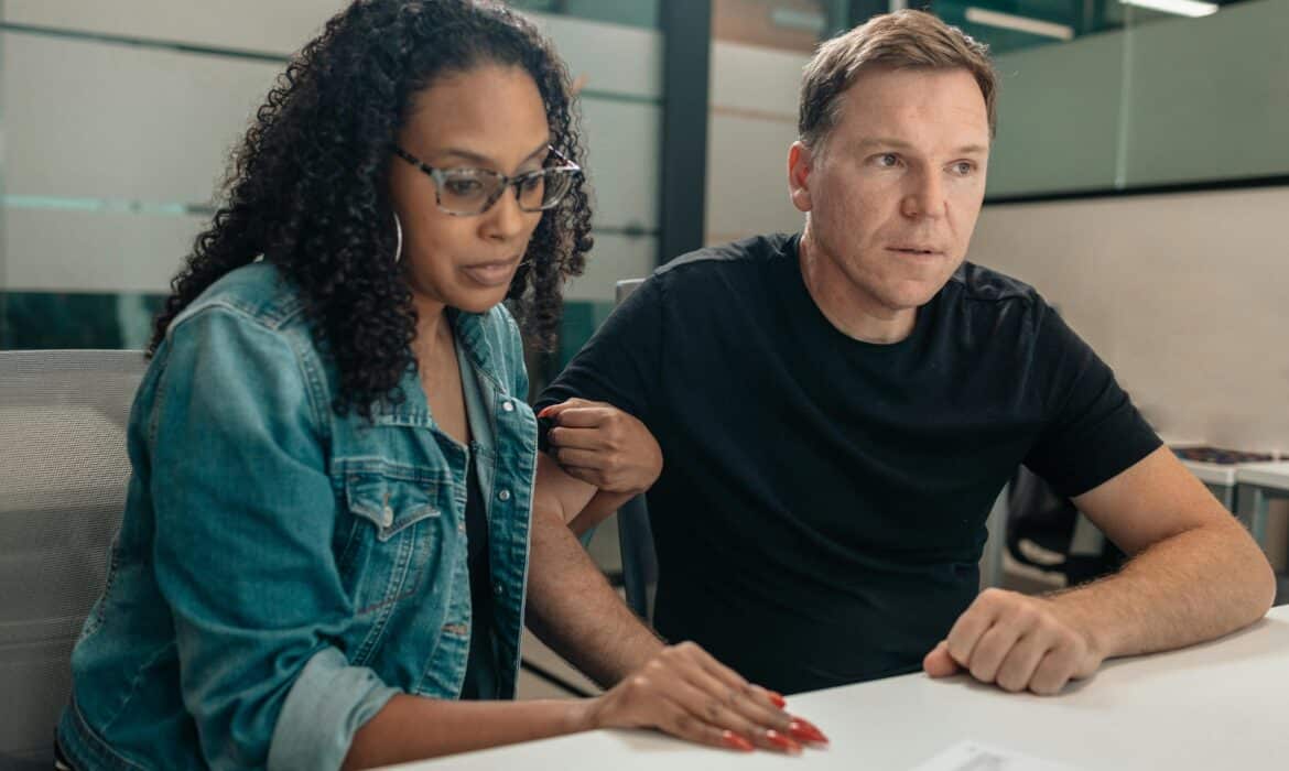 Couple at a desk having a consultation about cancer and sex