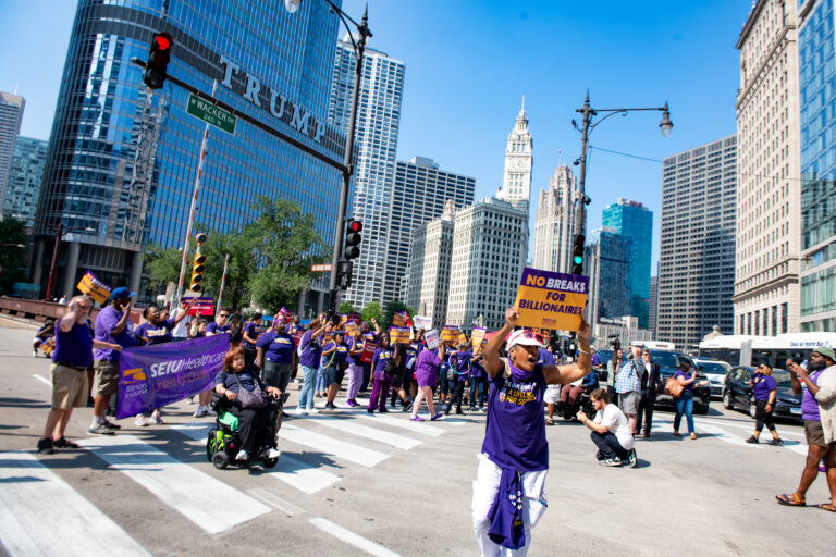 Healthcare workers and disability rights advocates march outside of Trump Tower in Chicago.