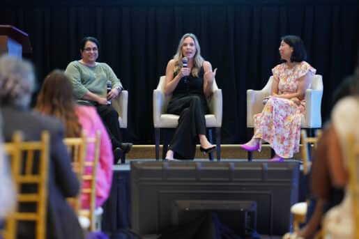 Three physicians on stage at the annual Women In Medicine Summit
