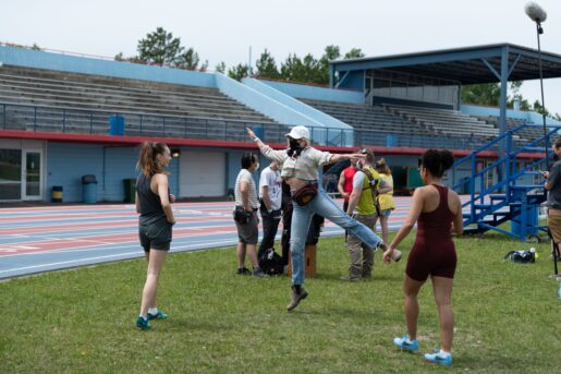 "Fitting In" writer and director Molly McGlynn (middle) on set with actors Maddie Ziegler (left) and Djouliet Amara.
