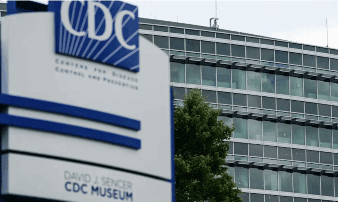 An outside view of the Centers for Disease Control and Prevention, with bullet holes visible in the windows, even at a distance
