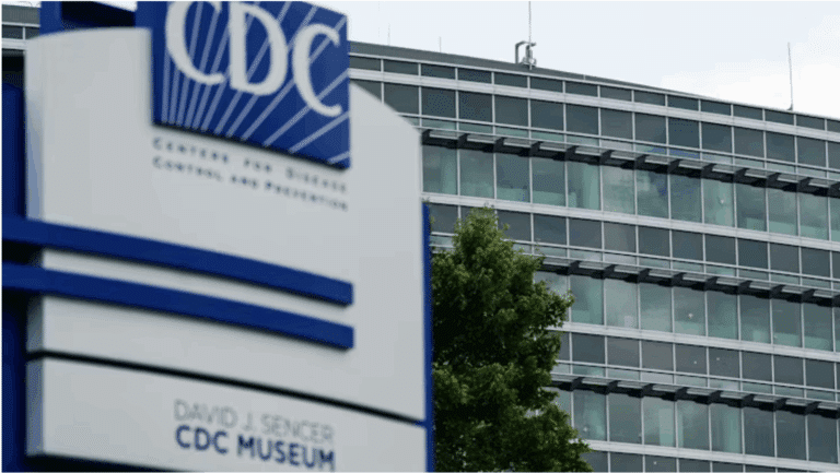 An outside view of the Centers for Disease Control and Prevention, with bullet holes visible in the windows, even at a distance