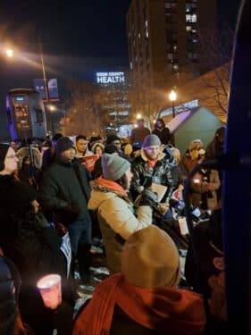 Healthcare workers gather outside the Jesse Brown VA in Chicago for a candlelight vigil