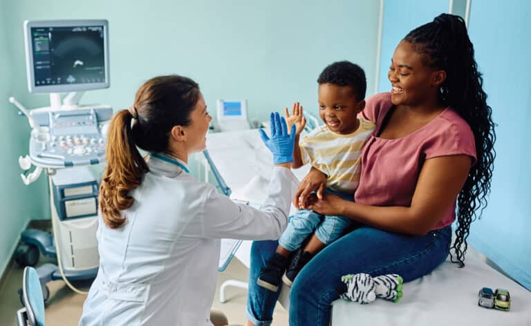 Mother and child at a doctor's visit. How people pay for care is changing. Representing direct primary care and concierge care