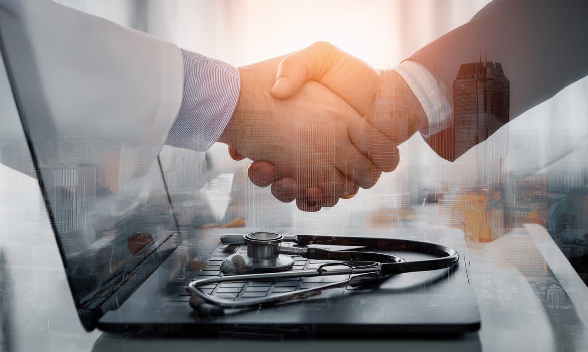 A businessman and a doctor shake hands representing private equity in healthcare
