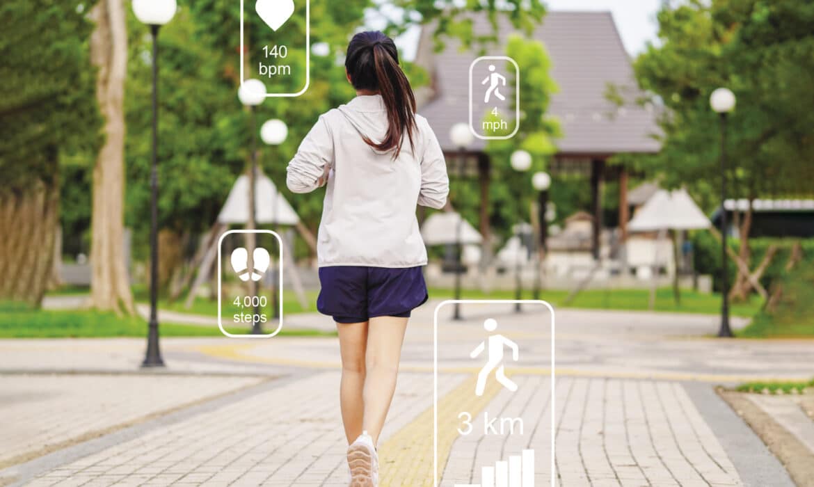 Woman jogging in the park with fitness trackers