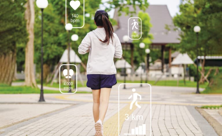 Woman jogging in the park with fitness trackers