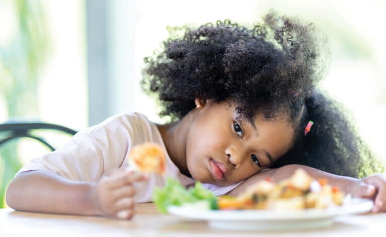 Child not eating her meal representing an eating disorder or being a picky eater. AFRID is one such disorder.