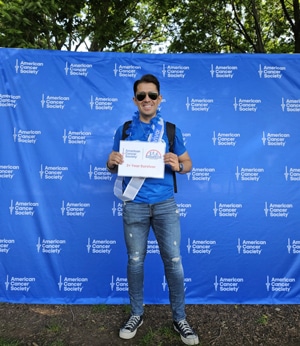 Jose Santos holding 3 year survivor sign