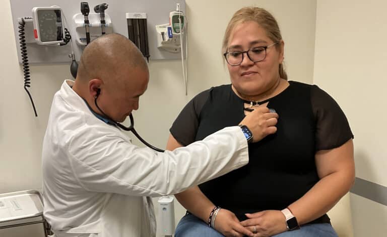 Dr. Simon Kim examines a patient