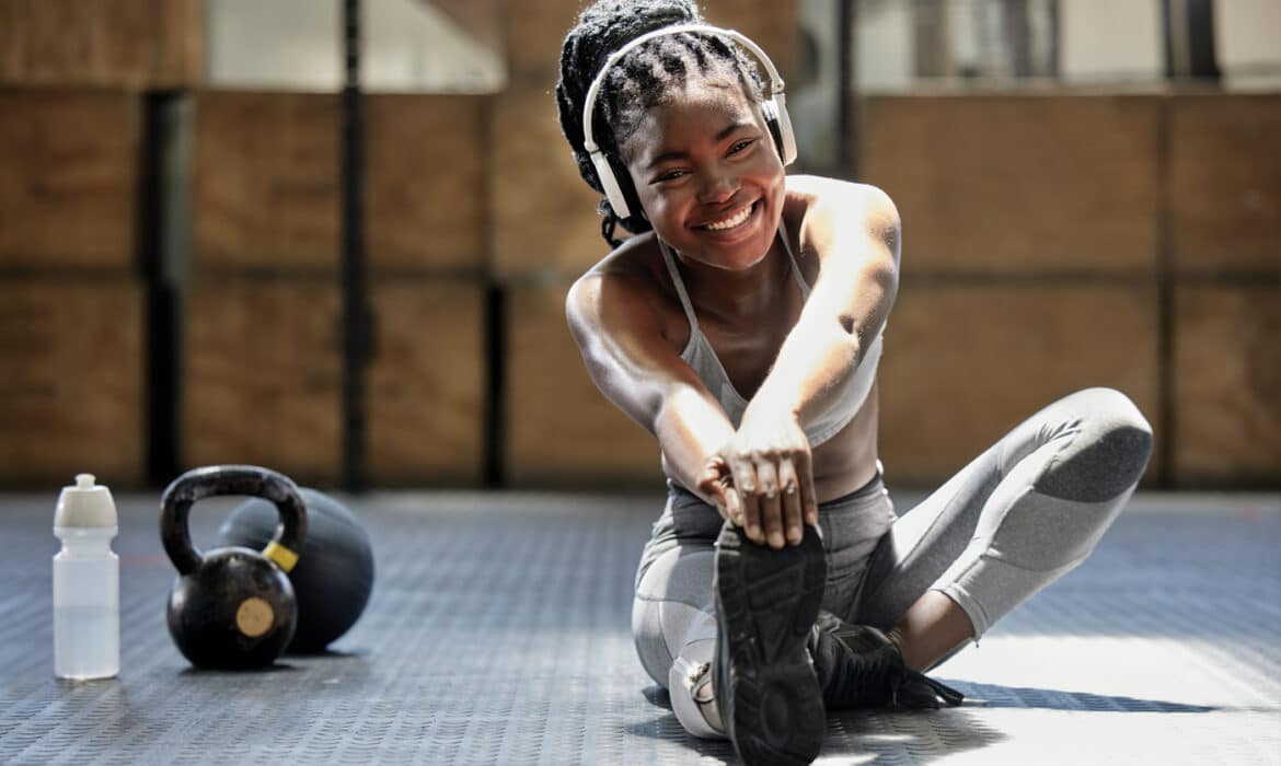Woman stretching on the floor of a gym