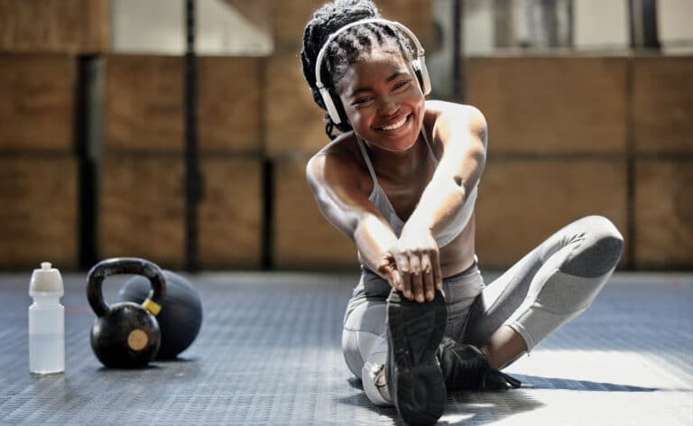 Woman stretching on the floor of a gym