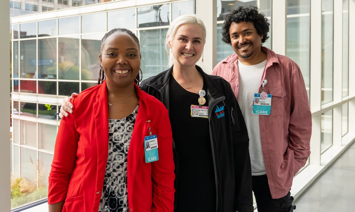 Caption: Peer patient advocates Ronisha Edwards-Elliott (left) and Ryan Cooper (right) pose with Paige Reilly, UIC professor of pediatric hematology-oncology in the College of Medicine. The three work at the S.T.A.R. Clinic, guiding adolescents with sickle cell disease.