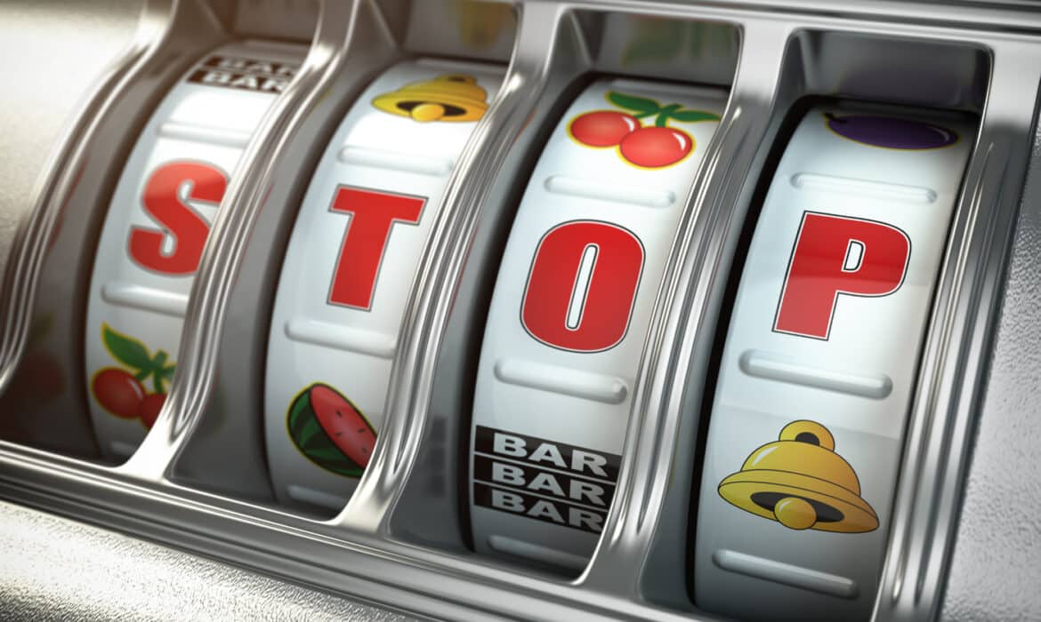 Gambling slot machine. The word stop displays in the window of the machine.