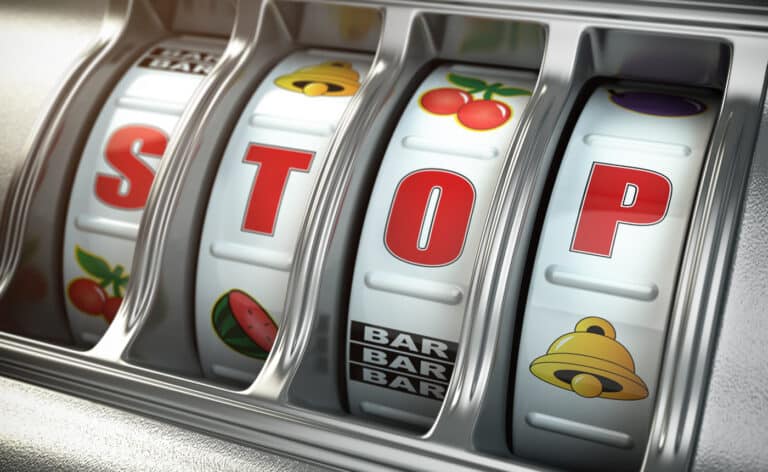 Gambling slot machine. The word stop displays in the window of the machine.