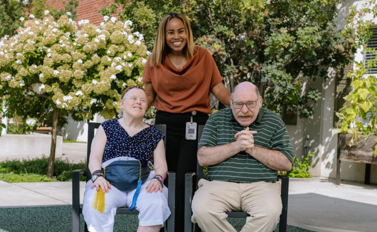 Susy Rivera, director at Quinlan Terrace, with two residents