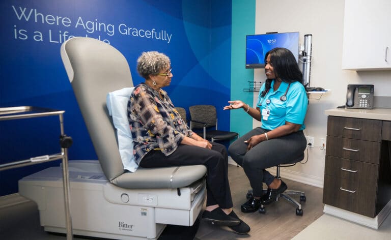 Nurse Practitioner LeShaun Williams consults a patient. Photo Courtesy of the Center for Better Aging