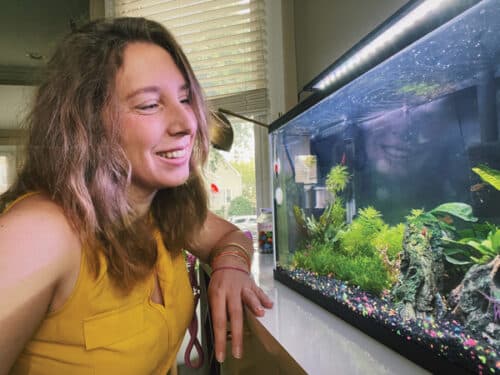 Katie Scarlett Brandt looking at her fishtank